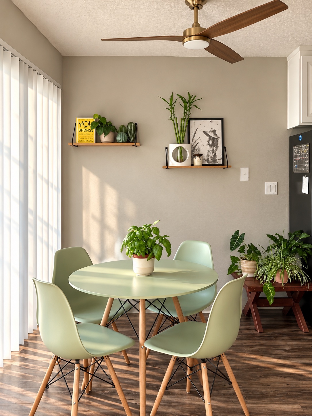 The same dining nook styled with a round table, sage chairs, and floating plant shelves