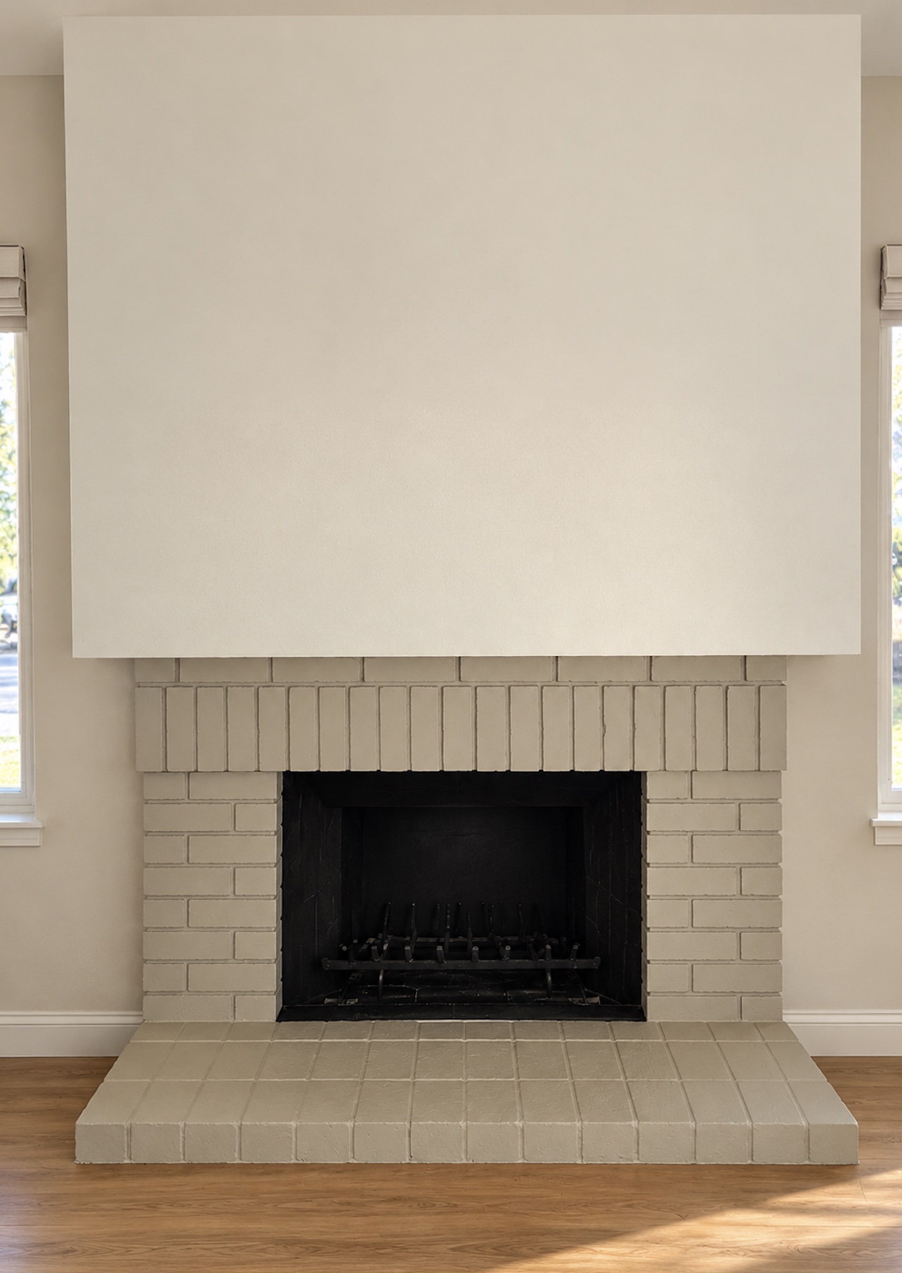 A plain beige brick fireplace, before styling